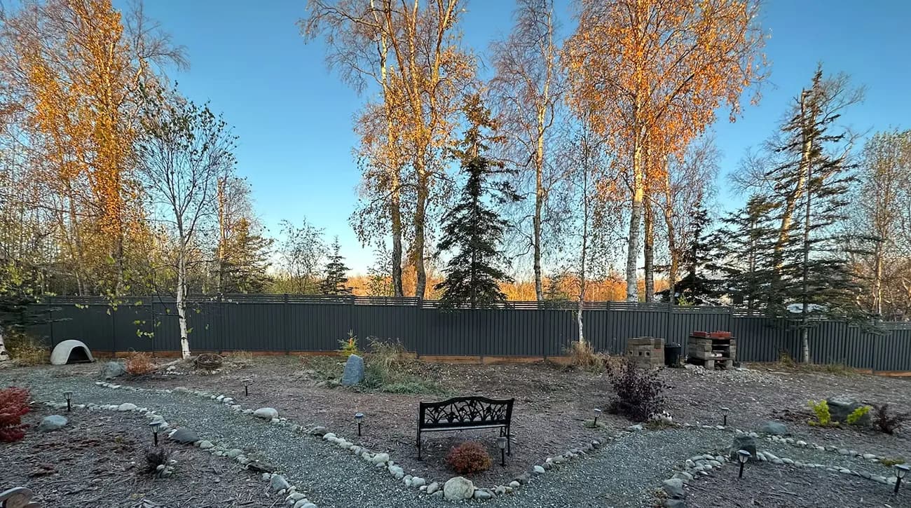 Wide metal privacy fence installation in a residential setting
