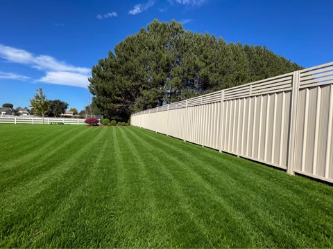 Long Single Color Steel privacy fence run