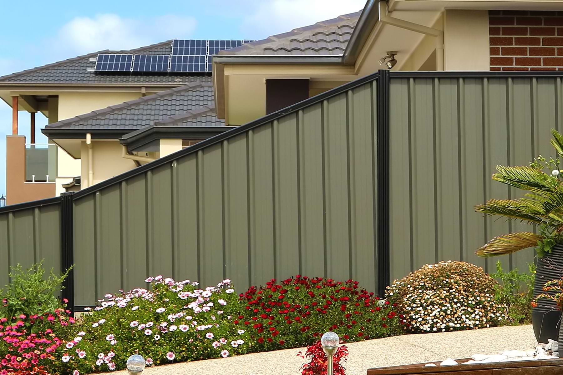 Installed steel privacy fence with landscaping