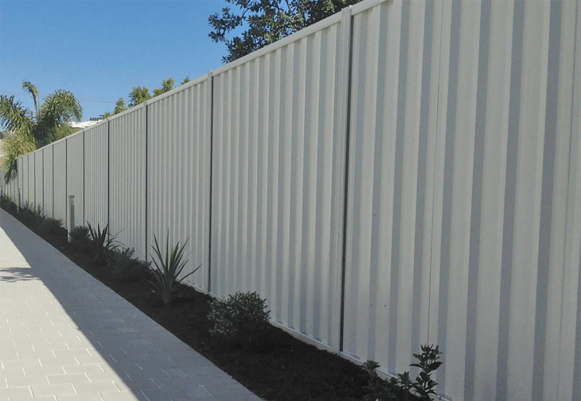 Metal privacy fence installed for full property screening